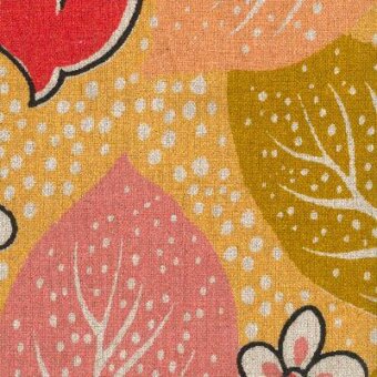 Floral fabric swatch with mustard yellow background, coral and red botanical motifs, black outlines, and scattered white speckles.